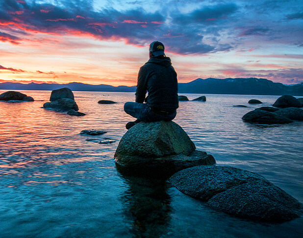 Man Sitting on Rock